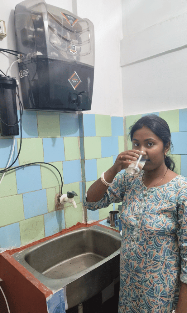 Urvashi Sarkar is drinking water from a Water Purifier