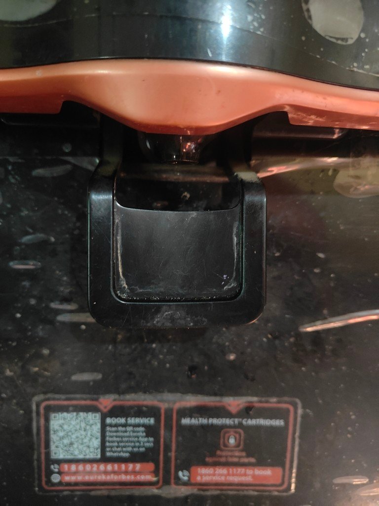 Close up of Aquaguard Enrich Marvel 2X RO water purifier tap outlet and dispensing lever on the front panel