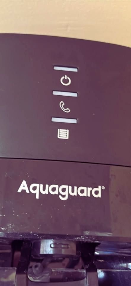 Aquaguard Sure Delight 2X RO water purifier control panel showing LED power indicator, purifying status light, and filter life